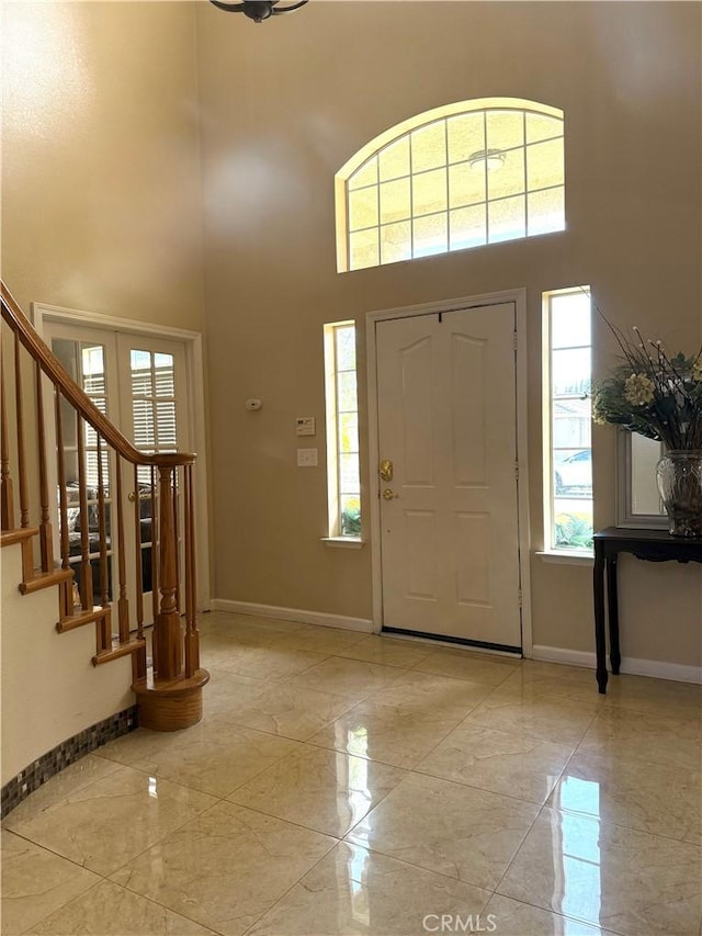 5170 Coronado St, Chowchilla, CA 93610 - entrance foyer featuring baseboards, stairs, marble finish floor, and a high ceiling