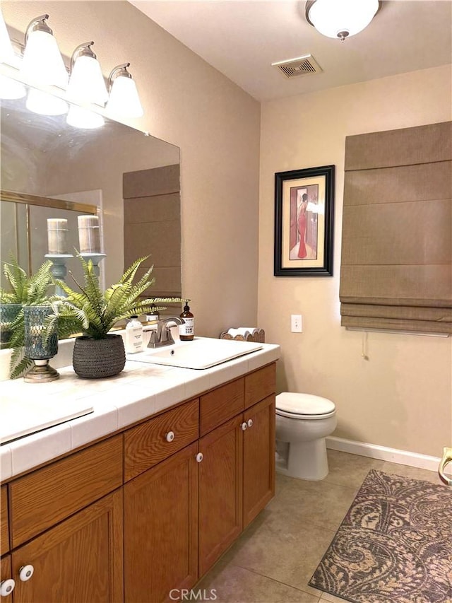 5170 Coronado St, Chowchilla, CA 93610 - full bathroom with visible vents, a stall shower, vanity, tile patterned floors, and toilet