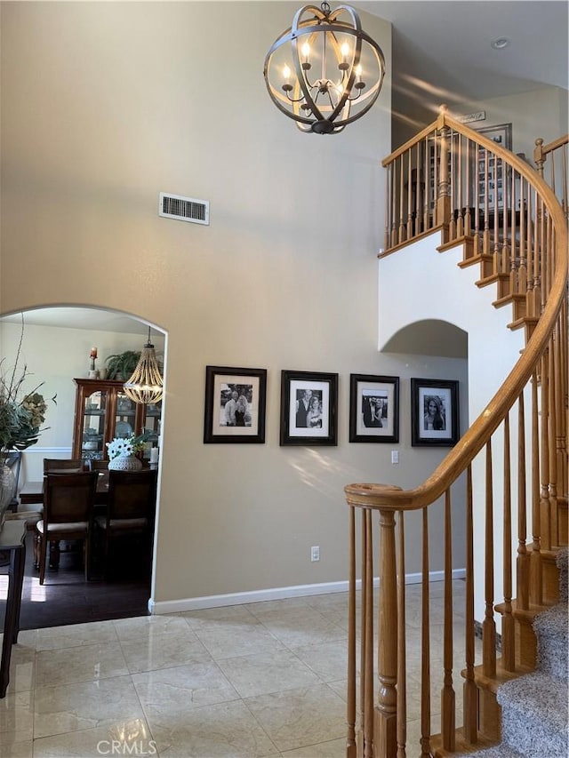 5170 Coronado St, Chowchilla, CA 93610 - stairway featuring a towering ceiling, visible vents, baseboards, and a chandelier