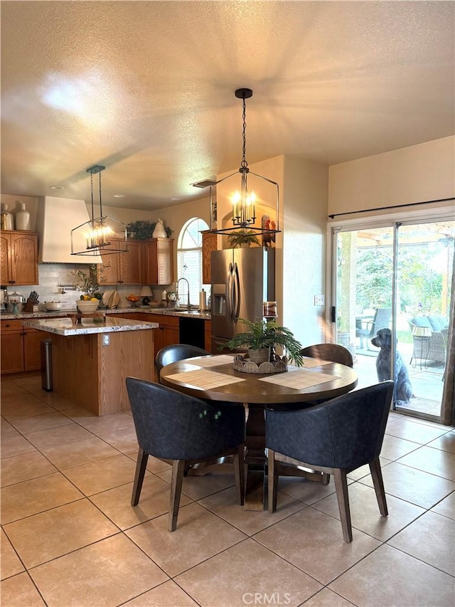 5170 Coronado St, Chowchilla, CA 93610 - dining room featuring a textured ceiling, a chandelier, and light tile patterned floors
