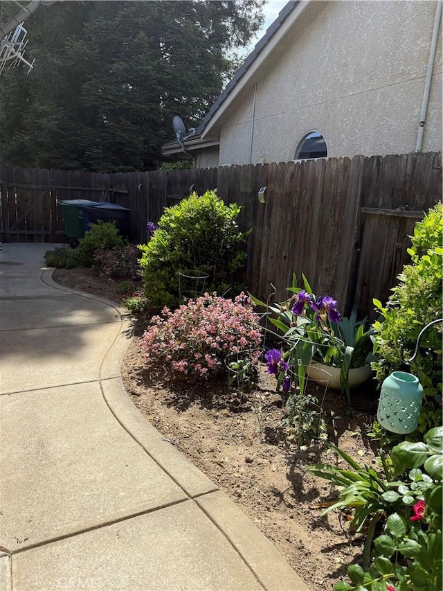 5170 Coronado St, Chowchilla, CA 93610 - view of side of home with fence, a patio, and stucco siding
