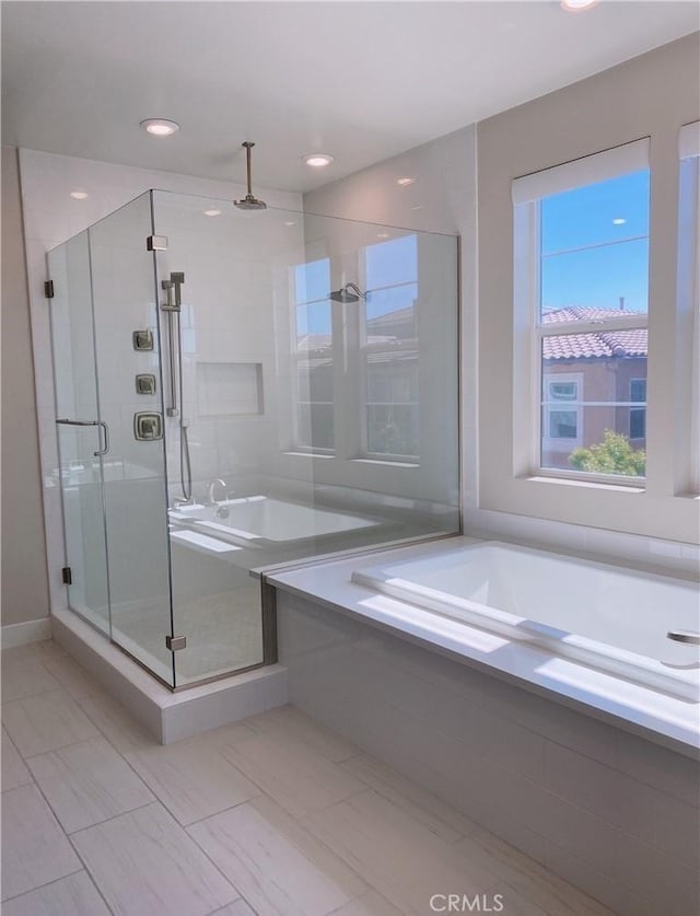 bathroom with a stall shower, recessed lighting, and a garden tub