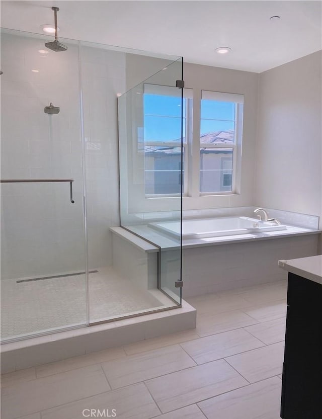 full bath featuring vanity, a shower stall, tile patterned floors, and a garden tub