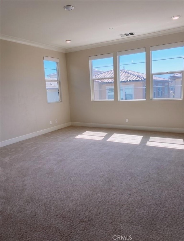 empty room featuring visible vents, baseboards, carpet floors, ornamental molding, and recessed lighting