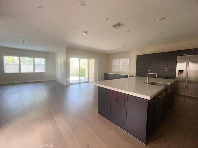 99 Swift, Irvine, CA 92618 - kitchen with a sink, high end fridge, open floor plan, light wood-style floors, and recessed lighting