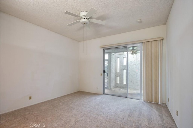 unfurnished room with a ceiling fan, carpet, and a textured ceiling