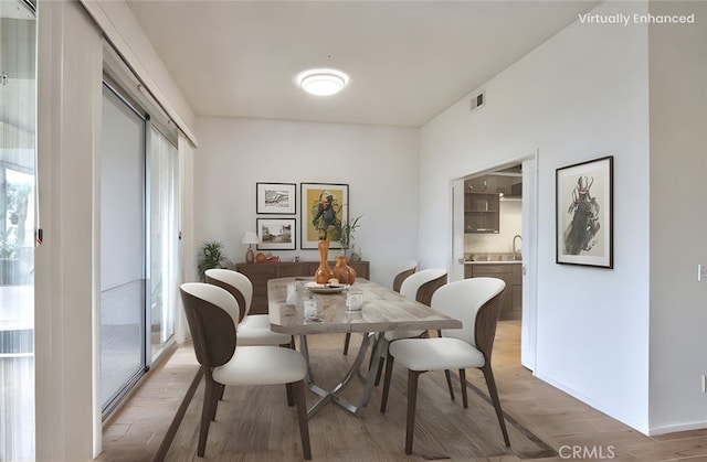 dining space featuring light wood finished floors and visible vents