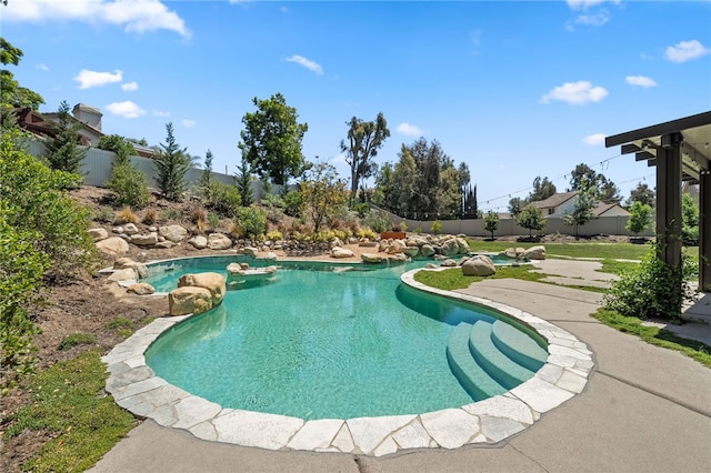view of swimming pool with fence