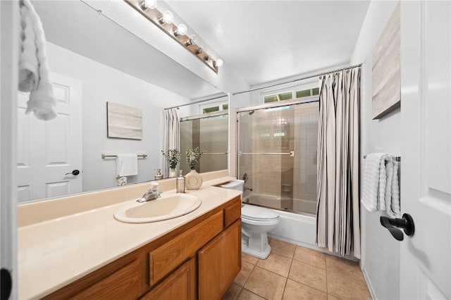 full bath featuring tile patterned floors, shower / bath combo with shower curtain, vanity, and toilet