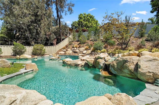 view of pool with a fenced backyard
