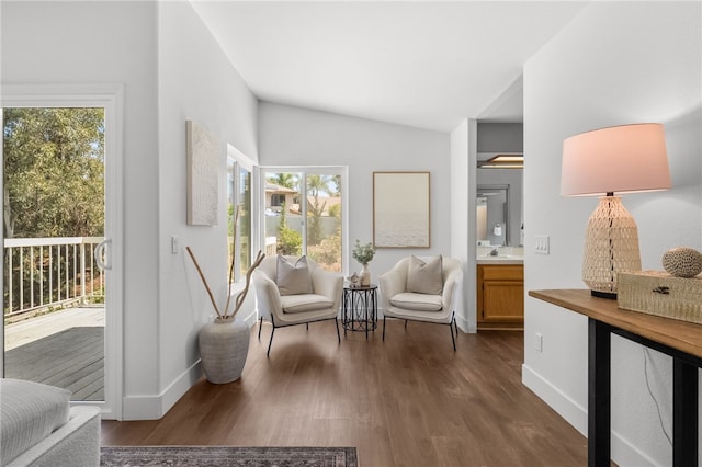 sitting room featuring dark wood finished floors, vaulted ceiling, and baseboards