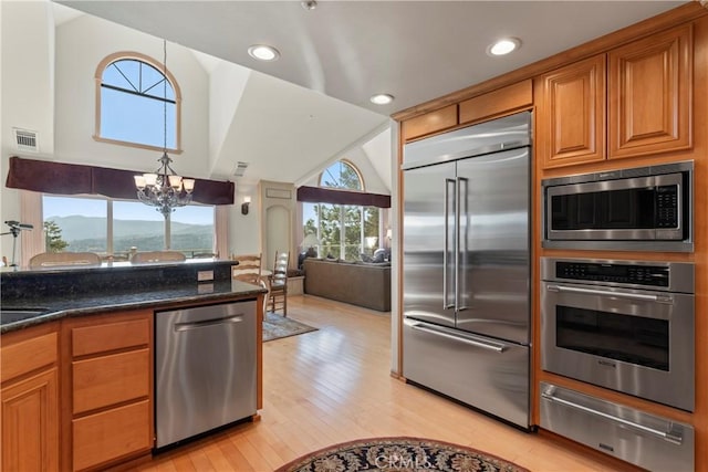 432 Grizzly Rd, Lake Arrowhead, CA 92352 - kitchen featuring built in appliances, a warming drawer, a chandelier, light wood finished floors, and brown cabinets
