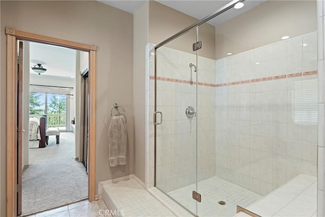 bathroom with a shower stall, tile patterned floors, and ensuite bathroom