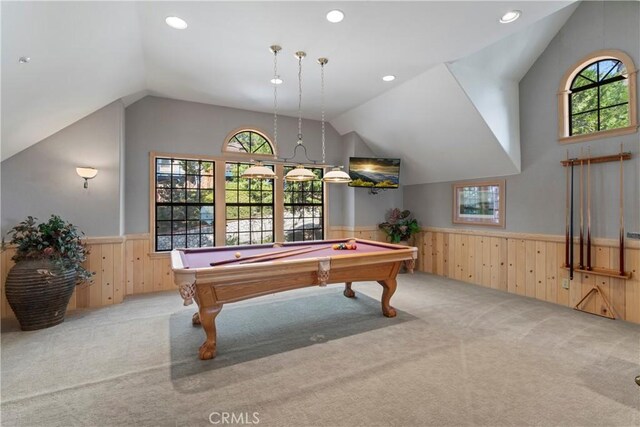 game room with wooden walls, a wainscoted wall, carpet floors, and lofted ceiling