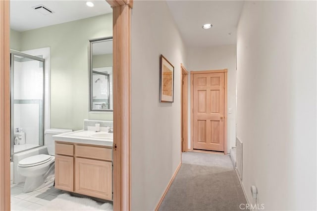 corridor featuring visible vents, recessed lighting, and a sink
