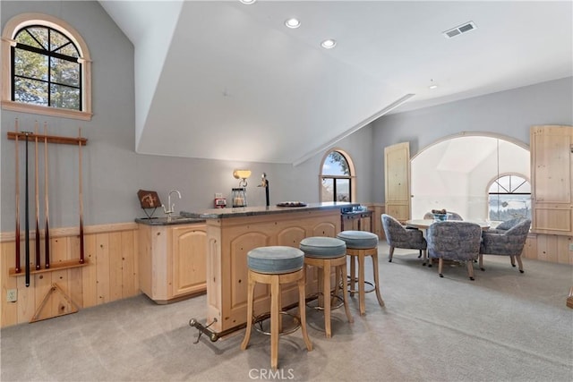 432 Grizzly Rd, Lake Arrowhead, CA 92352 - kitchen with light brown cabinets, light carpet, vaulted ceiling, wainscoting, and recessed lighting