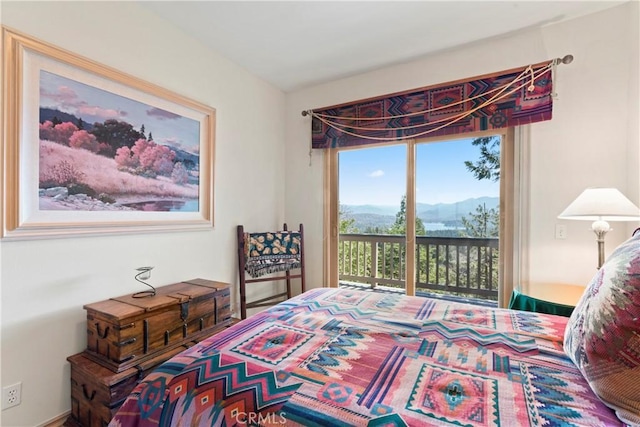 bedroom with a mountain view and access to outside