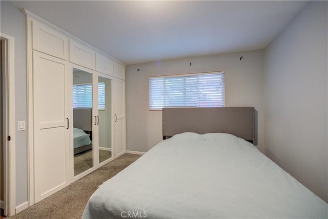 bedroom featuring carpet floors and baseboards