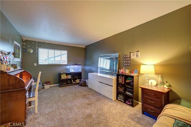 bedroom featuring baseboards, ornamental molding, and carpet flooring