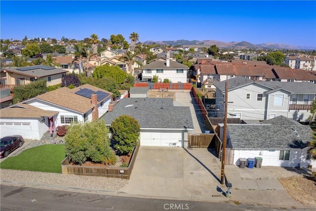 drone / aerial view featuring a residential view and a mountain view