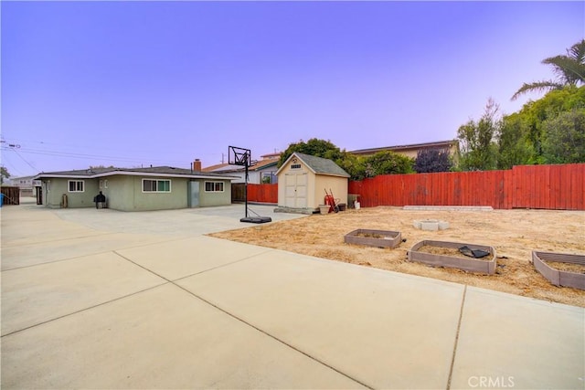 234 N 12th St, Grover Beach, CA 93433 - view of front of property with a garden, a patio, a fenced backyard, and a storage shed