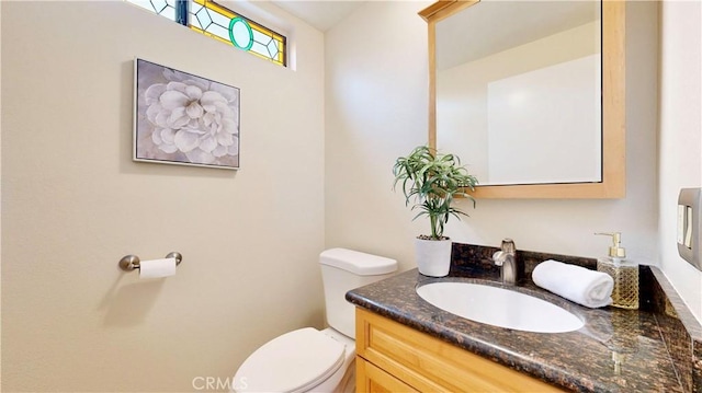 half bath featuring toilet and vanity