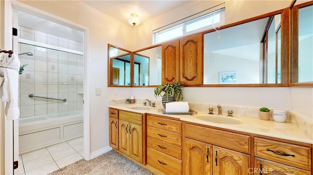 full bathroom with  shower combination, tile patterned flooring, a sink, and double vanity