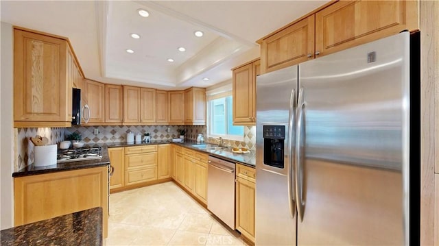 kitchen featuring light brown cabinets, decorative backsplash, a raised ceiling, appliances with stainless steel finishes, and recessed lighting