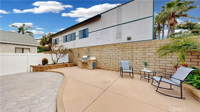 view of patio / terrace with area for grilling and a fenced backyard
