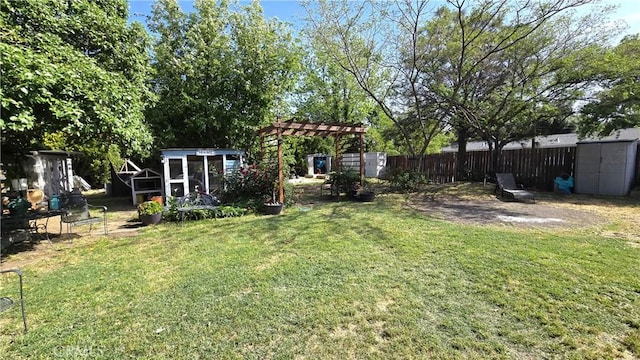 1954 Elizabeth Ave, Corning, CA 96021 - view of yard with fence, a pergola, an outdoor structure, and a shed