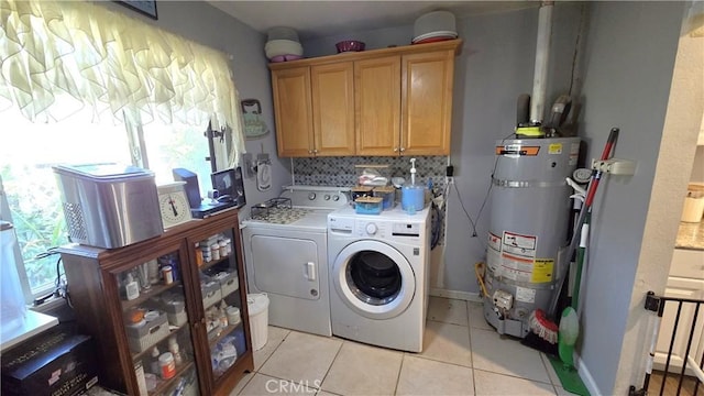 1954 Elizabeth Ave, Corning, CA 96021 - laundry room featuring washing machine and dryer, strapped water heater, light tile patterned floors, and cabinet space