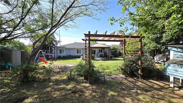 1954 Elizabeth Ave, Corning, CA 96021 - rear view of house featuring a pergola, a shed, an outbuilding, a patio, and a lawn