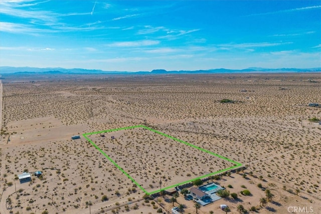 birds eye view of property with a mountain view, a desert view, and a rural view