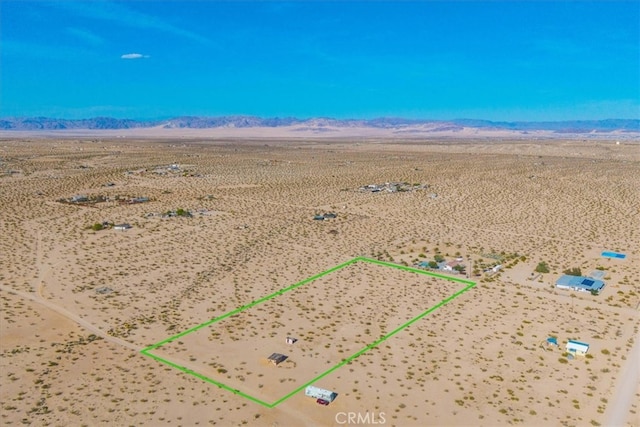 birds eye view of property featuring view of desert, a rural view, and a mountain view