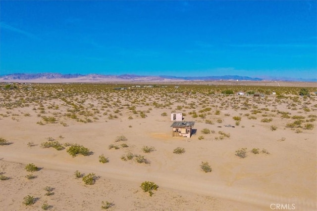exterior space featuring a rural view and a desert view