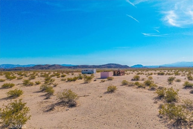 mountain view with a desert view and a rural view