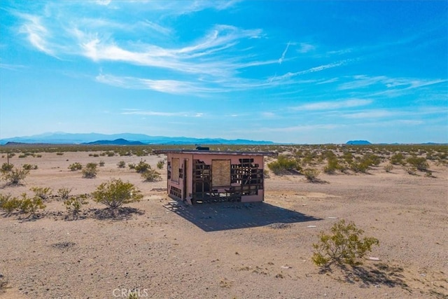 view of mountain feature featuring a rural view and view of desert