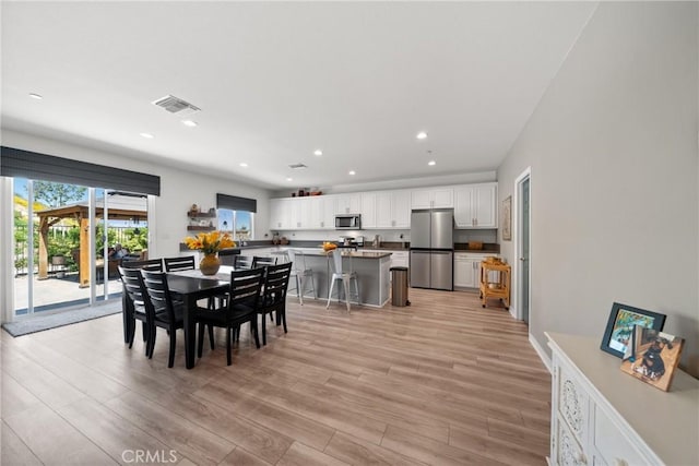 dining room with visible vents, recessed lighting, and light wood-type flooring