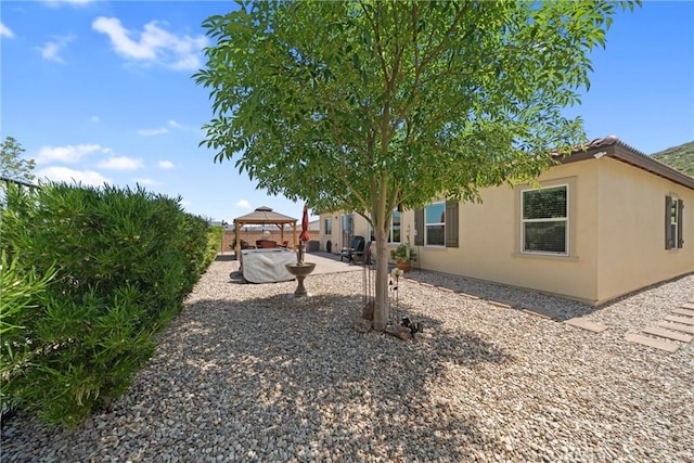 view of yard featuring a gazebo and a patio area