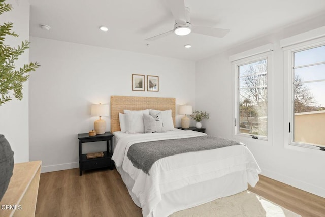 bedroom with baseboards, wood finished floors, recessed lighting, and ceiling fan
