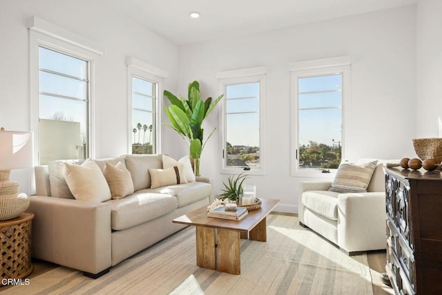 sitting room with recessed lighting, light wood finished floors, and baseboards