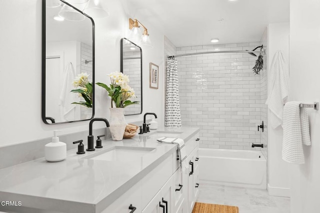 bathroom with a sink, shower / bath combo with shower curtain, and double vanity
