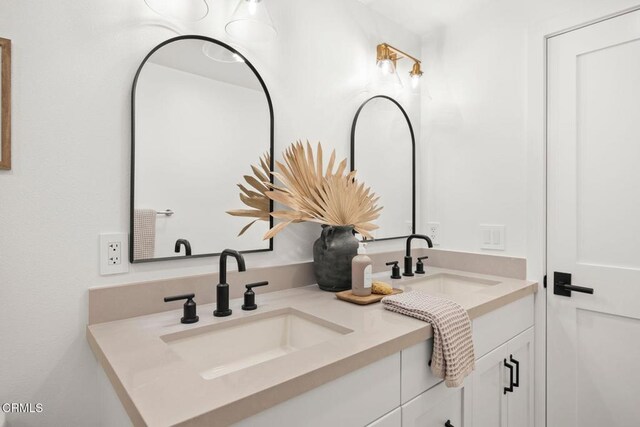 full bath featuring a sink and double vanity