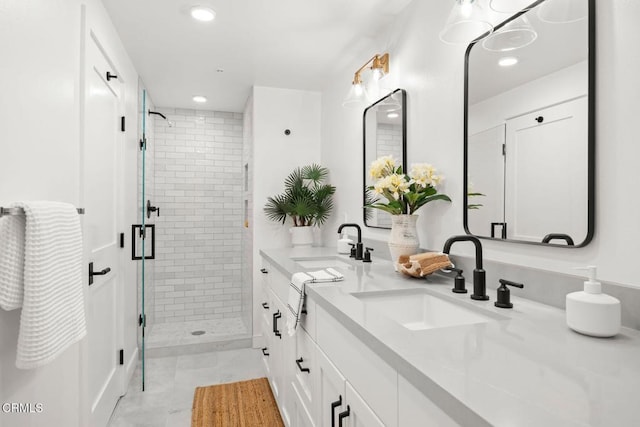 full bathroom with recessed lighting, a sink, double vanity, and a stall shower