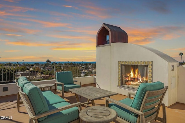 view of patio with a lit fireplace