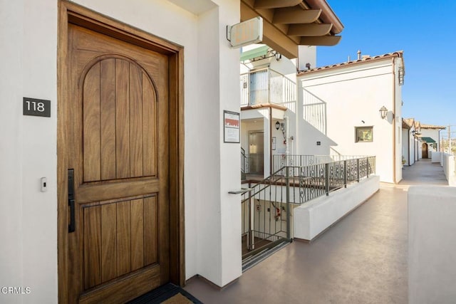 property entrance with stucco siding