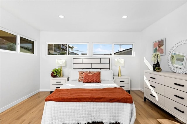 bedroom featuring recessed lighting, baseboards, and light wood-type flooring