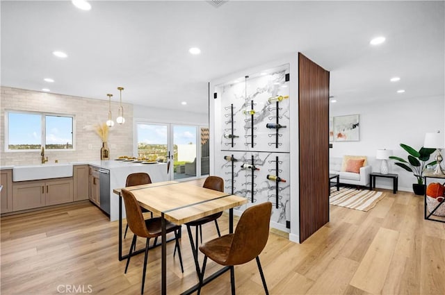 dining area featuring light wood-type flooring and recessed lighting