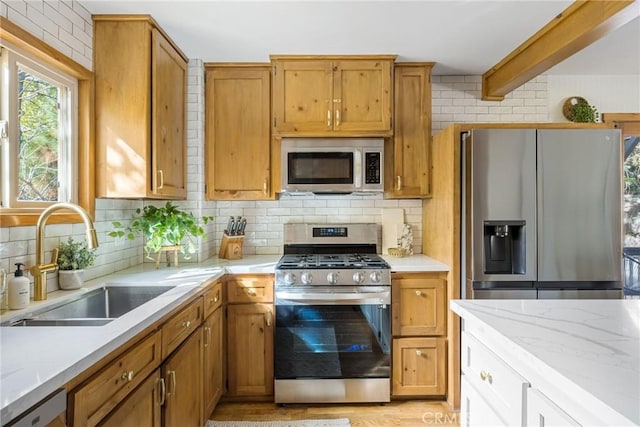 29387 Lake View Dr, Cedar Glen, CA 92321 - kitchen with light stone counters, a sink, stainless steel appliances, decorative backsplash, and light wood-type flooring