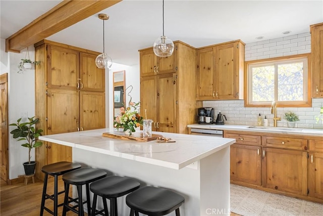 29387 Lake View Dr, Cedar Glen, CA 92321 - kitchen with a center island, a sink, a breakfast bar area, and hanging light fixtures